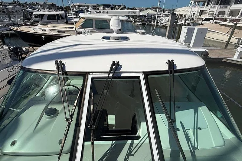 Slide: The Image of 2008 Tiara Yachts 3900 Sovran docked, showcasing sleek design and advanced navigation equipment. - 48