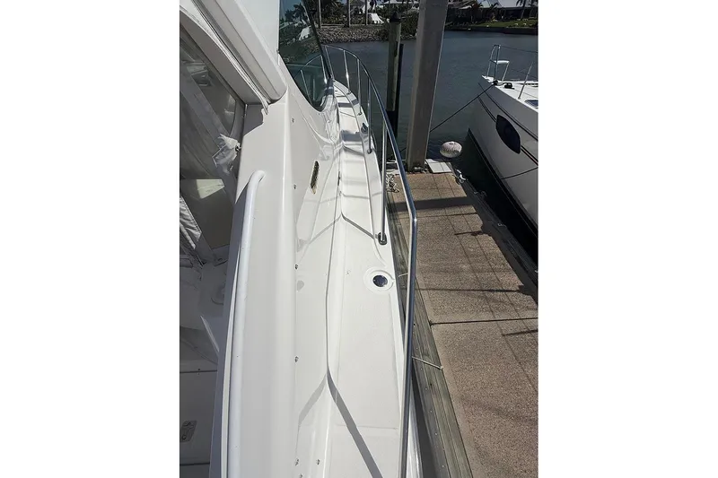 Slide: The Image of 2008 Tiara Yachts 3900 Sovran docked, showcasing sleek side deck and railing. - 5