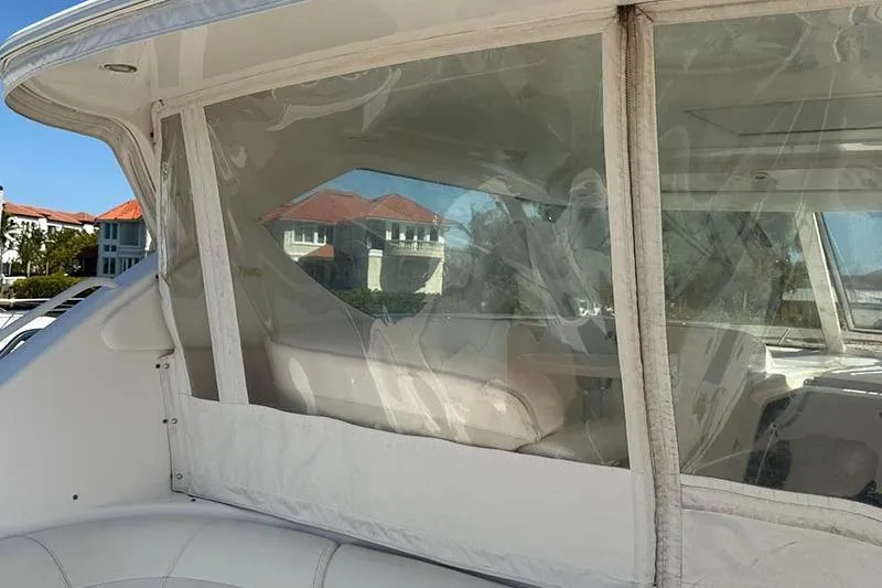 Slide: The Image of 2008 Tiara Yachts 3900 Sovran interior with clear enclosure and scenic background. - 51