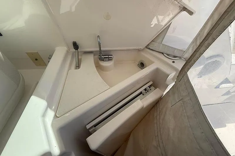 Slide: The Image of 2008 Tiara Yachts 3900 Sovran sink area with faucet and storage compartment. - 54