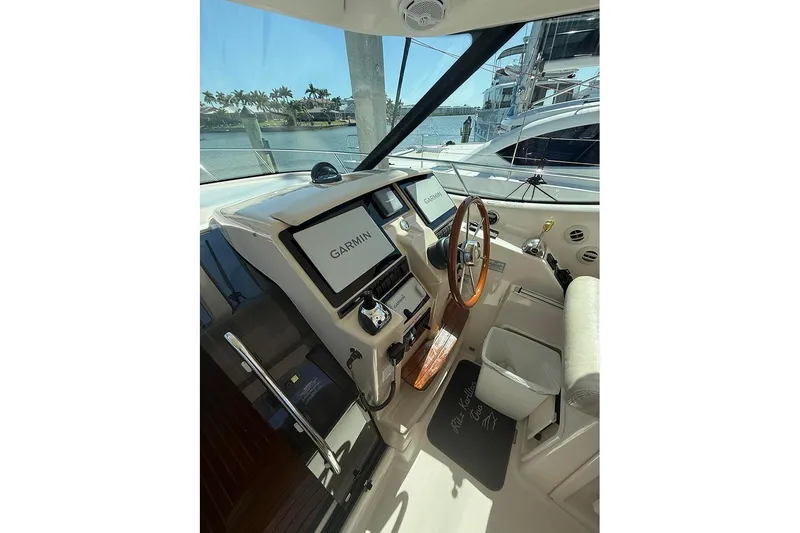 Slide: The Image of 2008 Tiara Yachts 3900 Sovran helm with Garmin navigation, wooden steering wheel, and luxurious seating. - 57