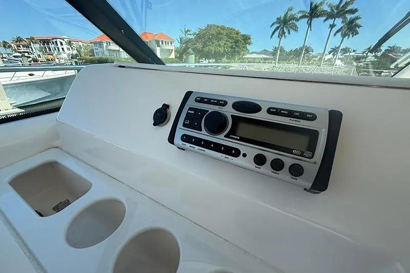 Slide: The Image of 2008 Tiara Yachts 3900 Sovran dashboard with stereo system and cup holders. - 61