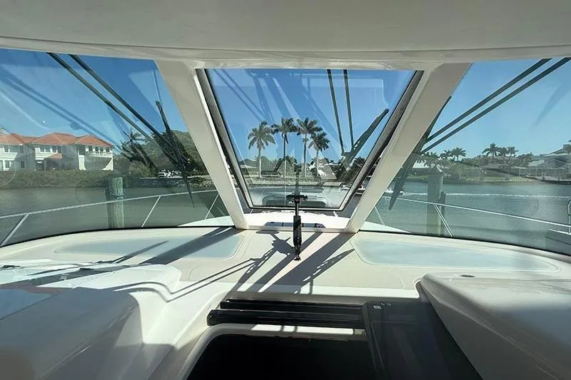 Slide: The Image of 2008 Tiara Yachts 3900 Sovran cockpit view with waterfront and palm trees. - 62