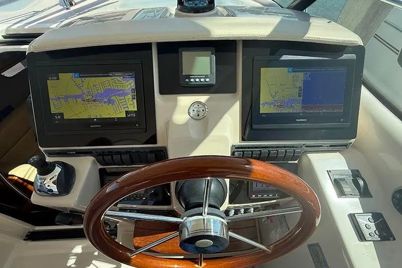 Slide: The Image of 2008 Tiara Yachts 3900 Sovran helm with dual Garmin displays and wooden steering wheel. - 64