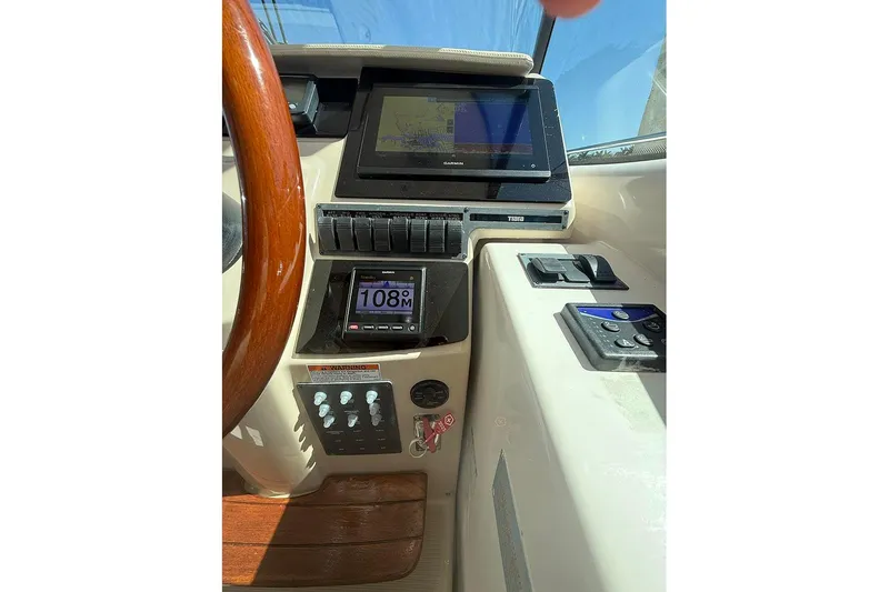 Slide: The Image of 2008 Tiara Yachts 3900 Sovran helm with navigation controls and display screens. - 66