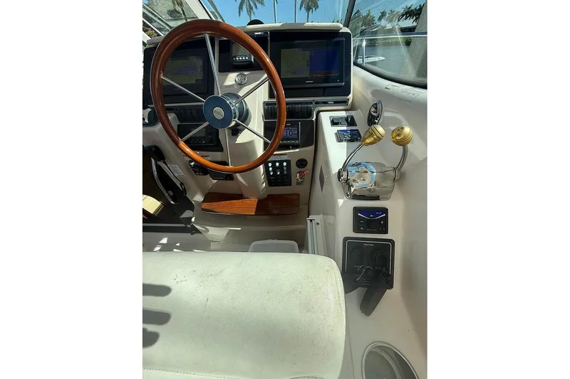 Slide: The Image of 2008 Tiara Yachts 3900 Sovran helm with wooden steering wheel and navigation displays. - 67