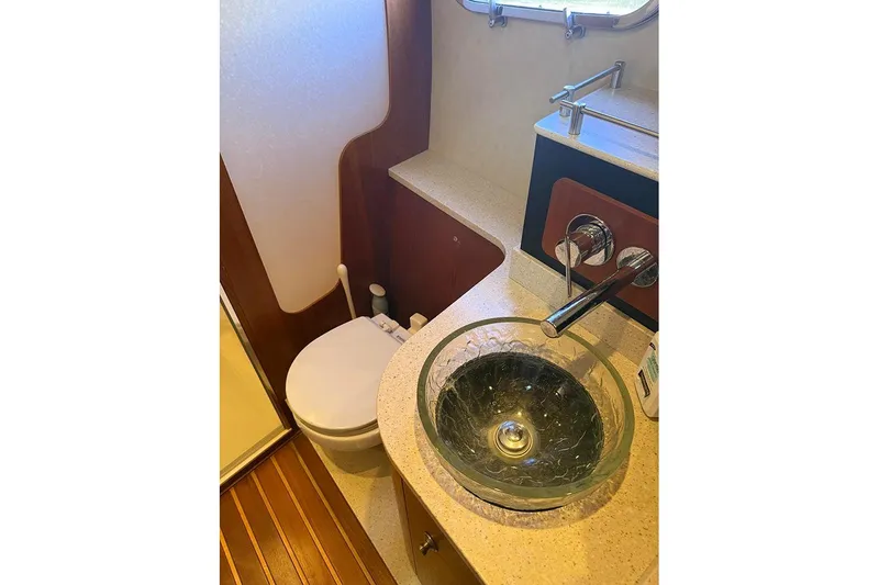 Slide: The Image of 2008 Tiara Yachts 3900 Sovran bathroom with glass sink and modern fixtures. - 79