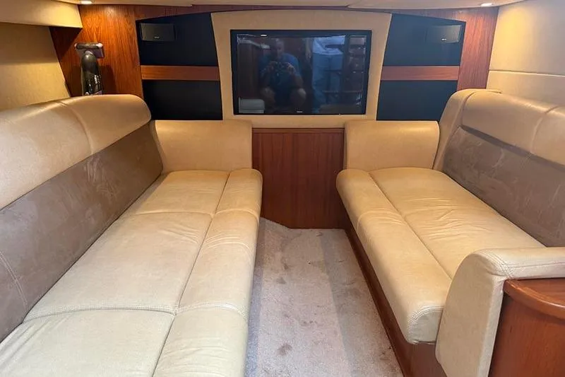 Slide: The Image of Interior of 2008 Tiara Yachts 3900 Sovran with beige seating and a flat-screen TV. - 85