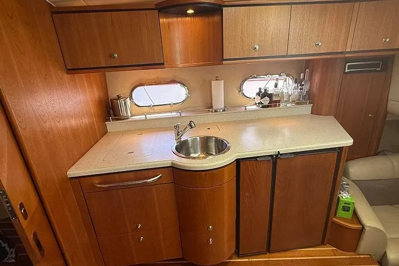 Slide: The Image of 2008 Tiara Yachts 3900 Sovran interior kitchen with wood cabinets and countertop. - 91
