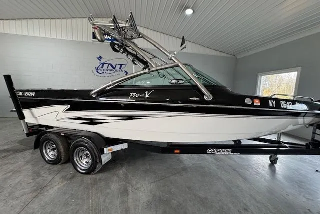 The Image of 2007 Calabria CAL AIR PRO V boat in showroom, black and white design, on trailer. - 1