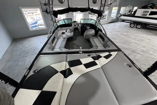 Slide: The Image of 2007 Calabria CAL AIR PRO V boat interior with checkered upholstery and spacious seating. - 4