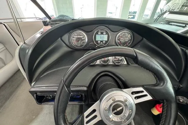 Slide: The Image of 2007 Calabria CAL AIR PRO V boat dashboard with steering wheel and gauges. - 6