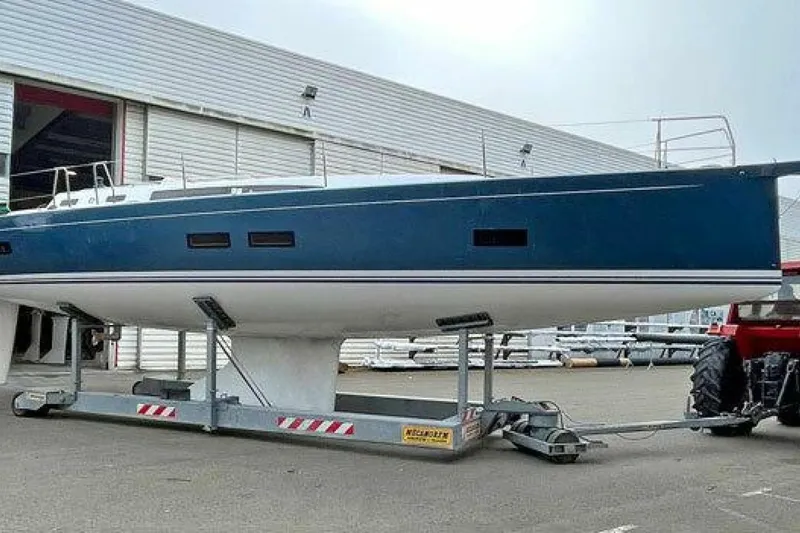 Slide: The Image of 2026 J Boats J/45 sailboat on trailer outside a warehouse. - 4