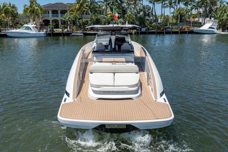 Slide: The Image of 2027 Solaris Power 40 Open yacht cruising on a sunny day, surrounded by palm trees. - 10