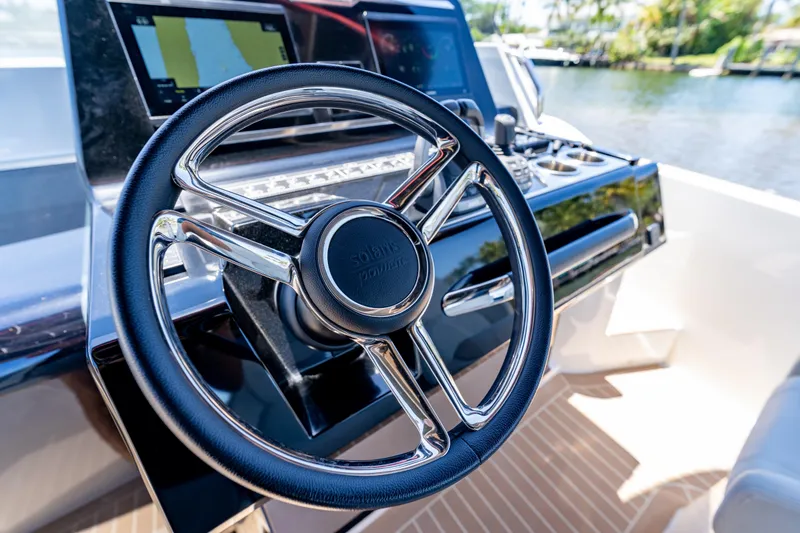 Slide: The Image of Steering wheel of 2027 Solaris Power 40 Open yacht, featuring modern navigation controls. - 19