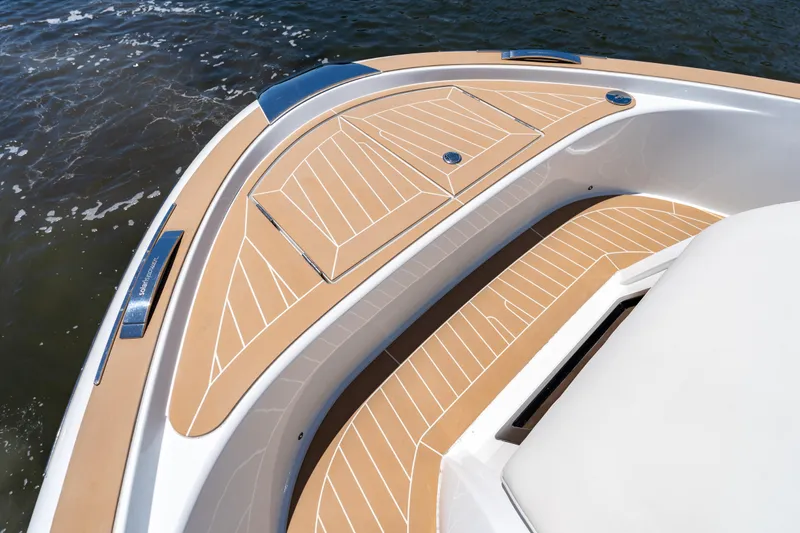 Slide: The Image of 2027 Solaris Power 40 Open yacht deck with sleek wood finish on water. - 24