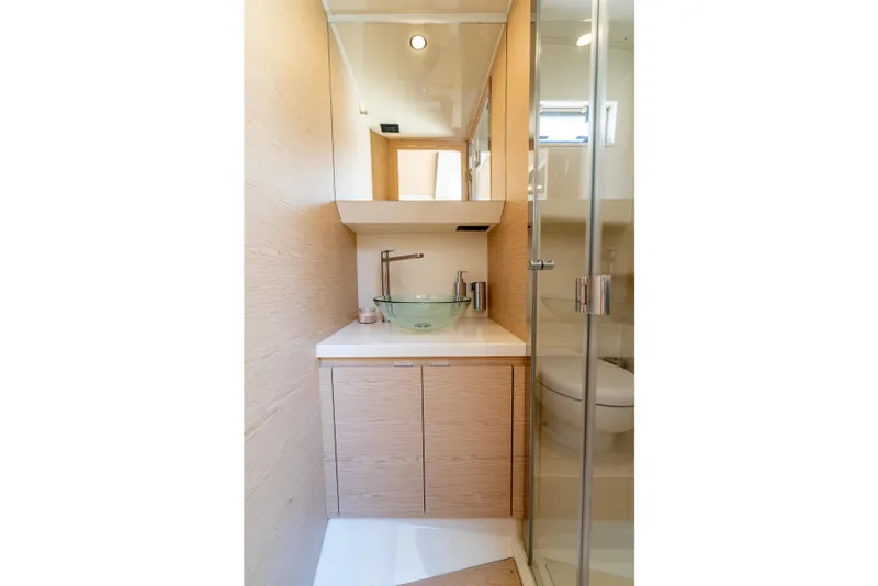 Slide: The Image of Modern bathroom in 2027 Solaris Power 40 Open yacht with glass sink and wooden cabinetry. - 41