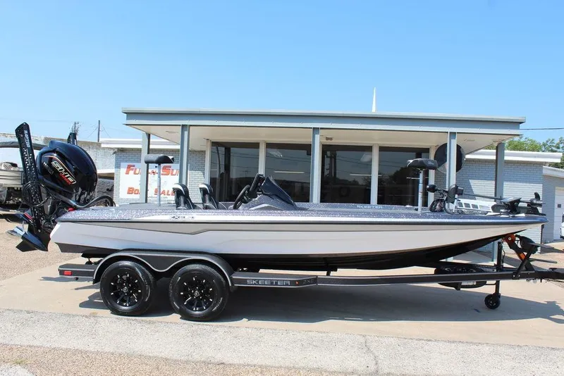 Slide: The Image of 2026 Skeeter ZXE21 boat on trailer outside dealership, featuring sleek design and modern equipment. - 1