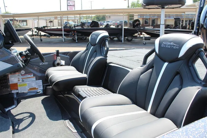 Slide: The Image of 2026 Skeeter ZXE21 boat interior with sleek seats and modern dashboard design. - 13