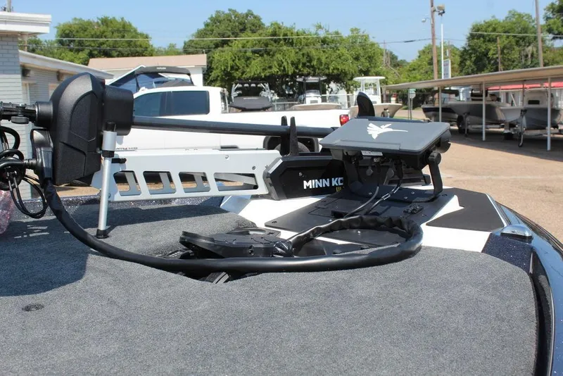 Slide: The Image of 2026 Skeeter ZXE21 boat with spacious deck and modern seating at a dealership. - 18