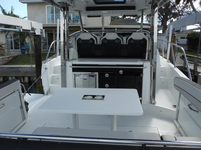 Slide: The Image of 2023 Jeanneau Leader 10.5 WA Series 2 boat interior with seating and table. - 15
