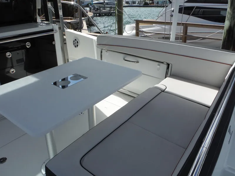 Slide: The Image of 2023 Jeanneau Leader 10.5 WA Series 2 boat interior with seating and table. - 17