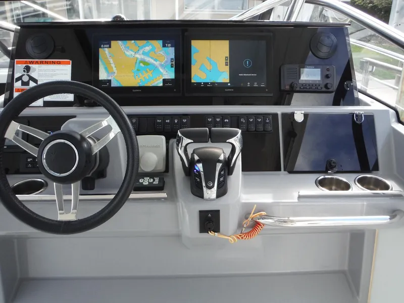 Slide: The Image of 2023 Jeanneau Leader 10.5 WA Series 2 helm with navigation screens and controls. - 20