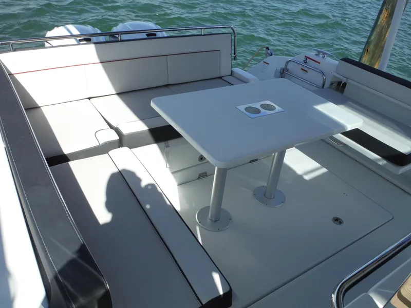 Slide: The Image of 2023 Jeanneau Leader 10.5 WA Series 2 boat interior with seating and table. - 42