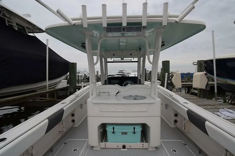 Slide: The Image of 2018 Robalo R302 Center Console boat docked at marina, featuring spacious deck and storage. - 17