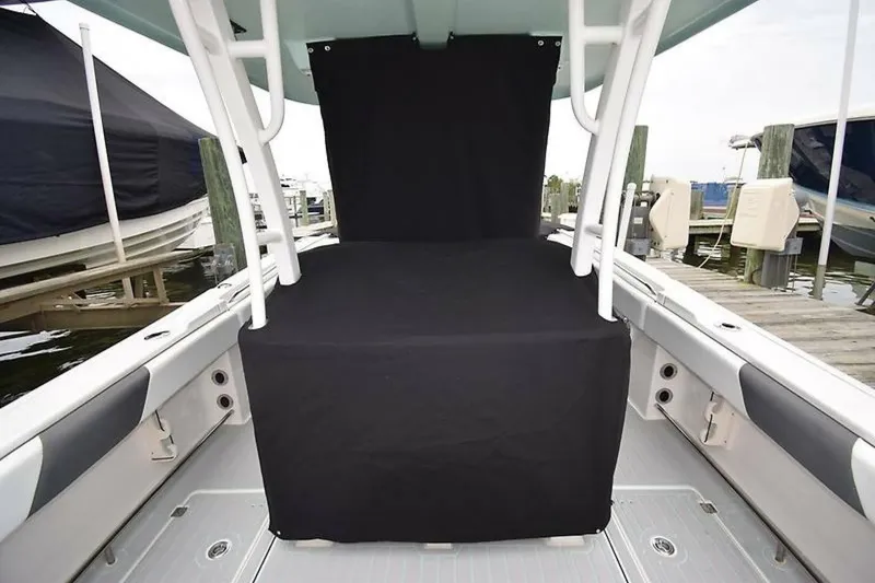 Slide: The Image of 2018 Robalo R302 Center Console boat interior with black cover, docked at marina. - 20