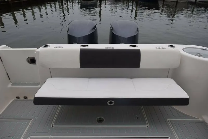 Slide: The Image of 2018 Robalo R302 Center Console boat with dual engines and cushioned seating. - 22