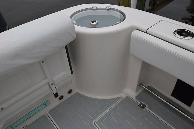 Slide: The Image of 2018 Robalo R302 Center Console boat interior with seating and livewell. - 24
