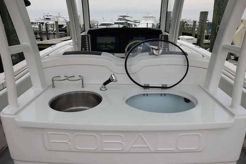 Slide: The Image of 2018 Robalo R302 Center Console boat with sink and storage area. - 25