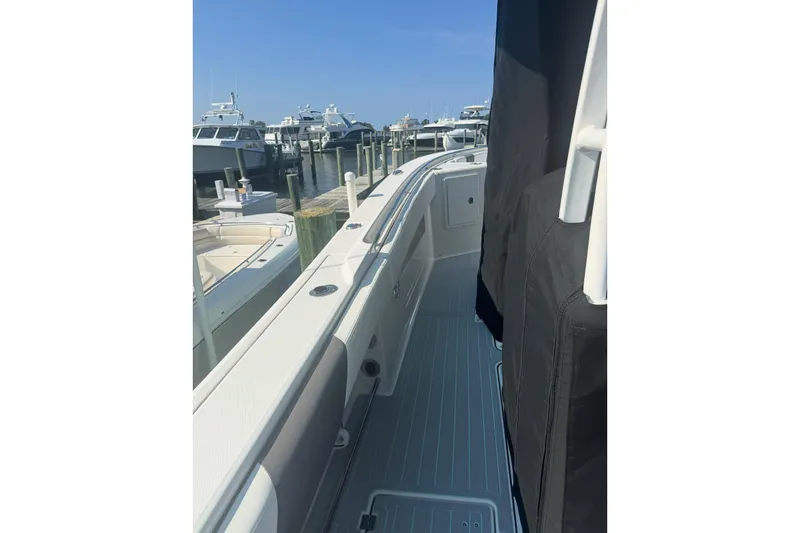 Slide: The Image of 2018 Robalo R302 Center Console boat docked at marina, side view. - 26
