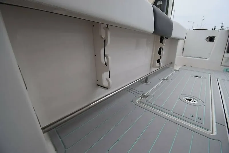 Slide: The Image of 2018 Robalo R302 Center Console boat interior with storage and seating. - 28