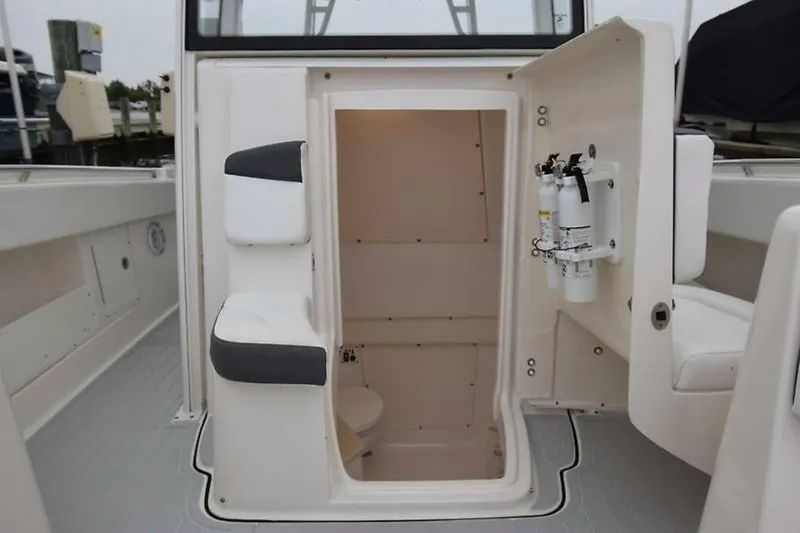 Slide: The Image of 2018 Robalo R302 Center Console interior with storage and safety equipment. - 29