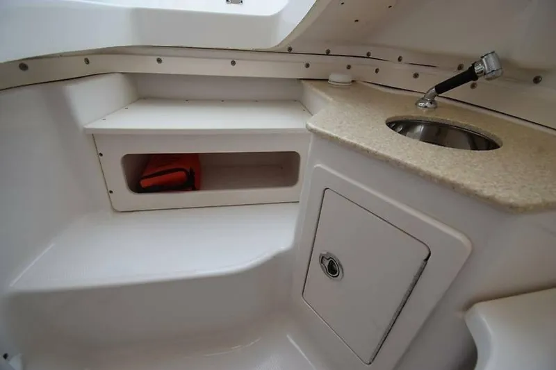 Slide: The Image of 2018 Robalo R302 Center Console interior with sink, storage, and countertop. - 30