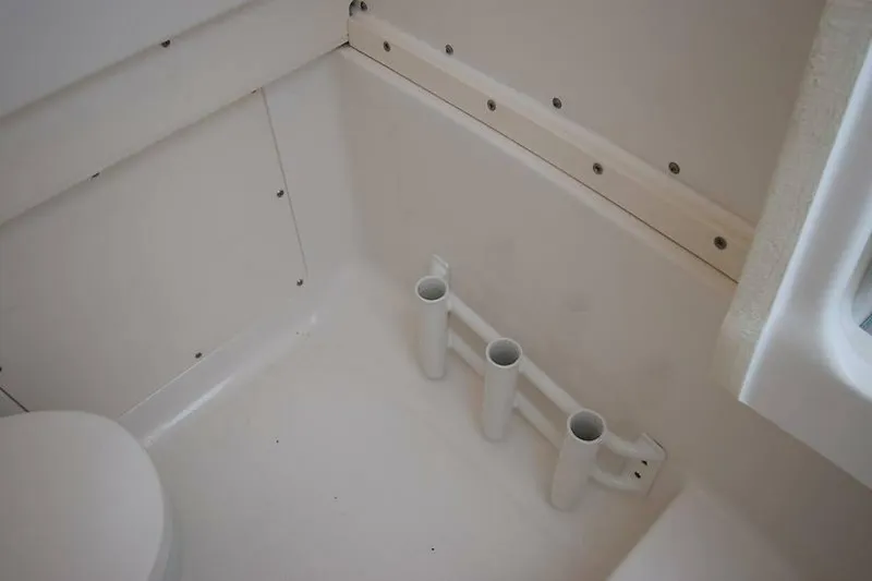 Slide: The Image of 2018 Robalo R302 Center Console interior with rod holders and seating area. - 31