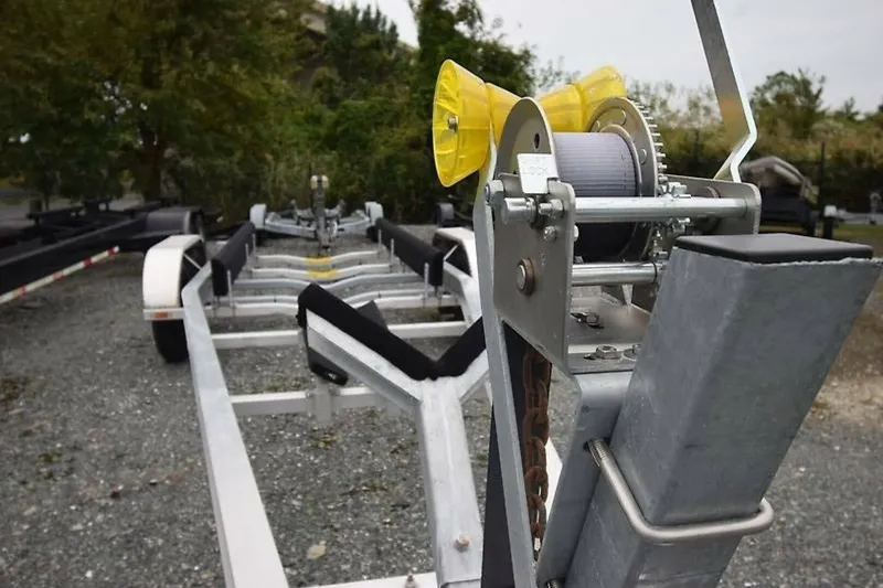 Slide: The Image of Trailer for 2018 Robalo R302 Center Console boat, featuring winch and rollers. - 38