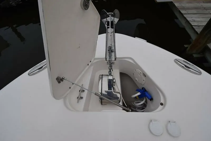 Slide: The Image of 2018 Robalo R302 Center Console anchor compartment with open hatch and equipment. - 6