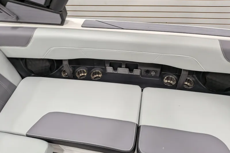 Slide: The Image of 2026 Malibu Wakesetter 20 VTX interior seating with cup holders and sleek design. - 13