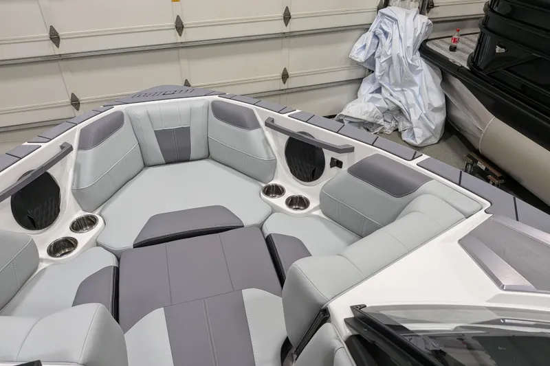 Slide: The Image of 2026 Malibu Wakesetter 20 VTX boat interior with gray seating and cup holders. - 15