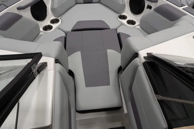 Slide: The Image of Interior of 2026 Malibu Wakesetter 20 VTX boat with gray seating and cup holders. - 16