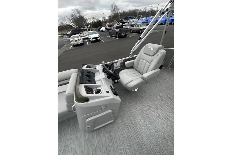 Slide: The Image of 2023 Bennington 21 SL boat interior with captain's chair and control console. - 17
