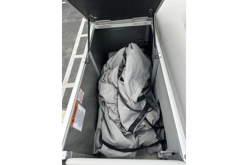 Slide: The Image of Storage compartment of 2023 Bennington 21 SL boat with cover inside. - 20