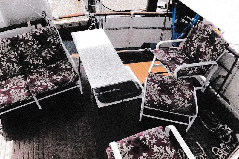 Slide: The Image of 1984 President D/C Motoryacht/Trawler deck with floral cushioned seating and table. - 12
