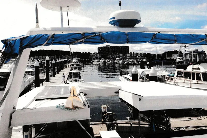 Slide: The Image of 1984 President D/C Motoryacht/Trawler docked at a marina with other boats. - 13