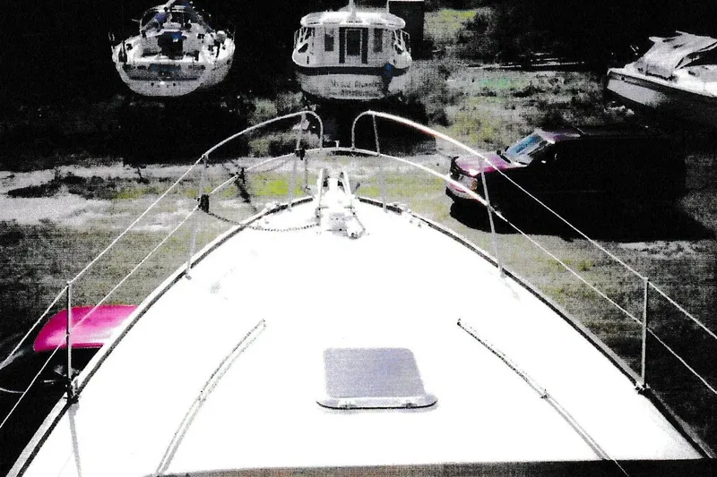 Slide: The Image of 1984 President D/C Motoryacht/Trawler on land with cars and boats nearby. - 16