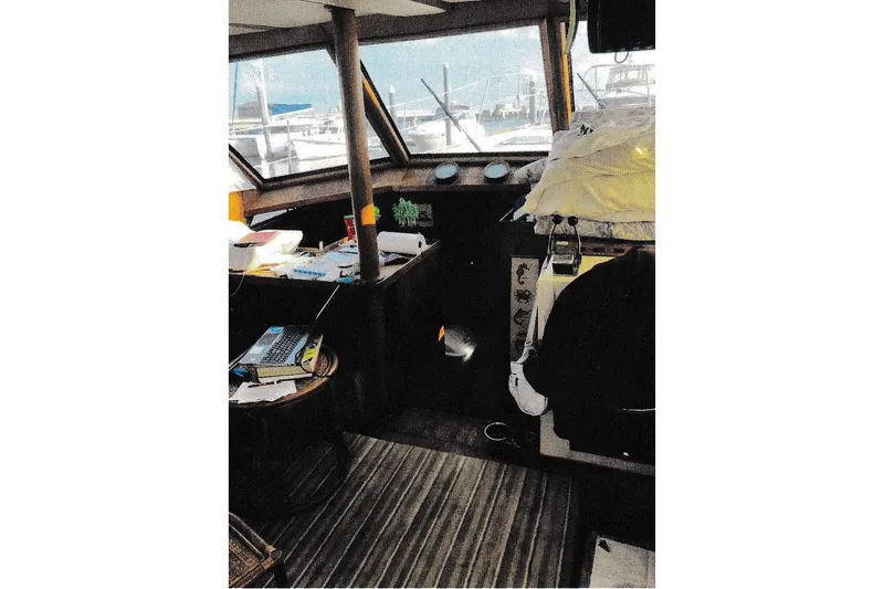 Slide: The Image of 1984 President D/C Motoryacht/Trawler interior with helm, windows, and nautical equipment. - 3