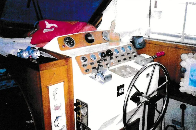 Slide: The Image of 1984 President D/C Motoryacht/Trawler helm with steering wheel and control panel. - 4
